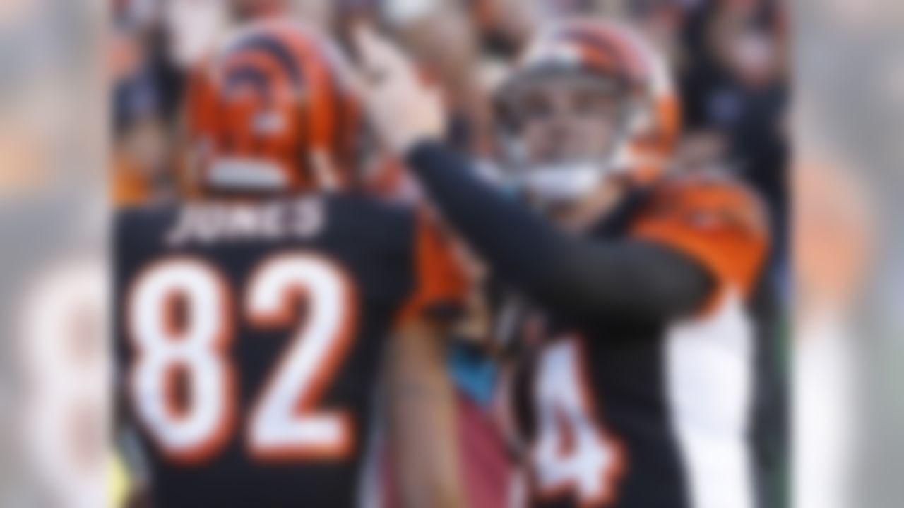 Cincinnati Bengals quarterback Andy Dalton (14) congratulates wide receiver Marvin Jones (82) after they combined on their third touchdown pass of the game in the first half of an NFL football game against the New York Jets, Sunday, Oct. 27, 2013, in Cincinnati. (AP Photo/David Kohl)