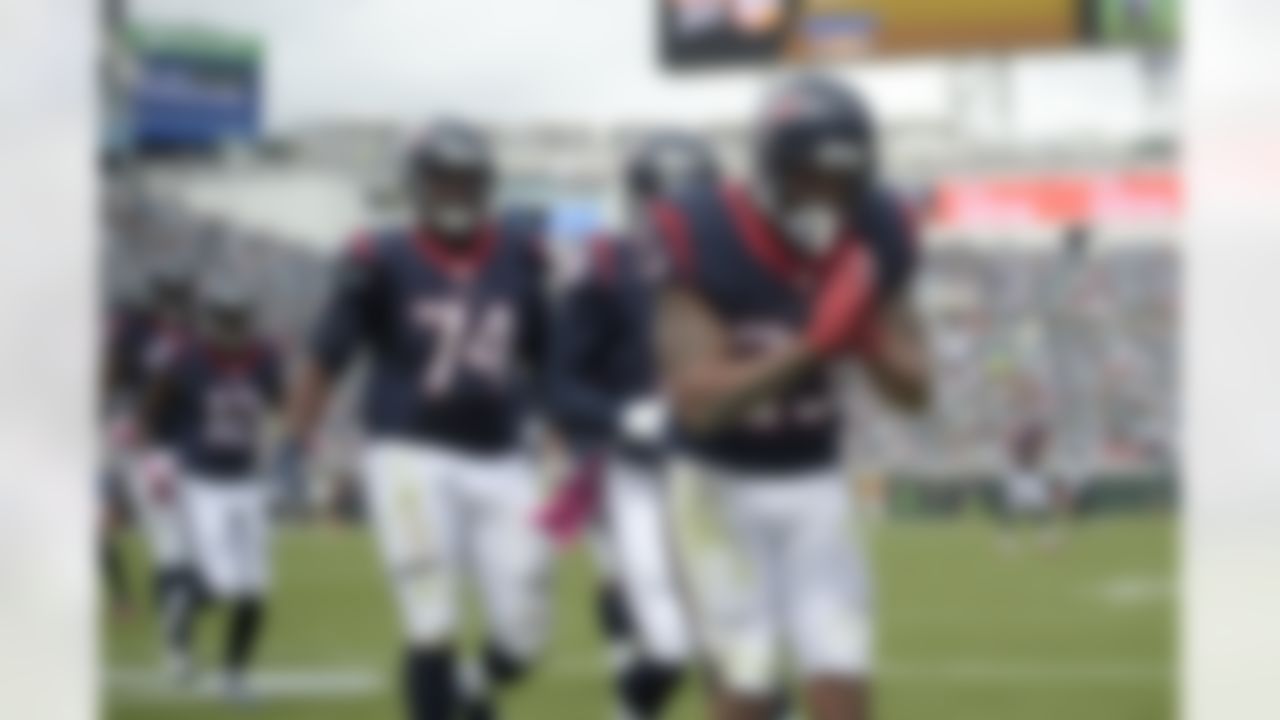 Houston Texans running back Arian Foster (23) celebrate after rushing for a touchdown as tackle Chris Clark (74) and wide receiver Cecil Shorts (18) come to congratulate him during the first half an NFL football game against the Jacksonville Jaguars in Jacksonville, Fla., Sunday, Oct. 18, 2015. (AP Photo/Phelan M. Ebenhack)
