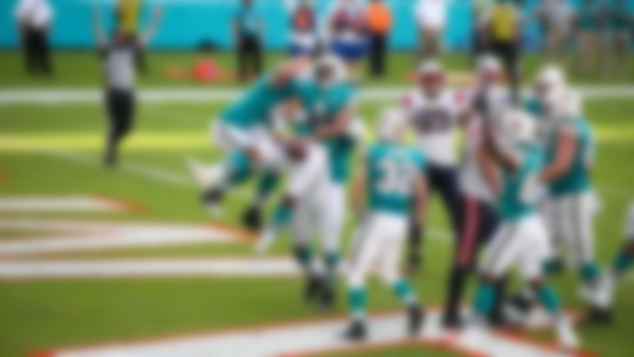 Miami Dolphins quarterback Tua Tagovailoa (1) celebrates with teammates in Sunday's victory over the New England Patriots.