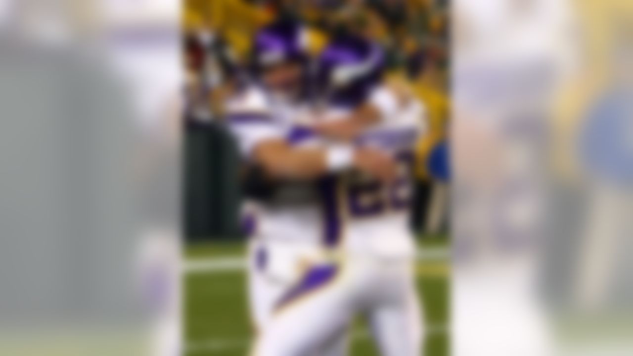 Minnesota Vikings' Brett Favre and Adrian Peterson celebrate after Favre threw a touchdown against the Green Bay Packers. Favre threw four touchdowns in the game tying a NFL record 21 times in his career. (Ben Liebenberg/NFL.com)