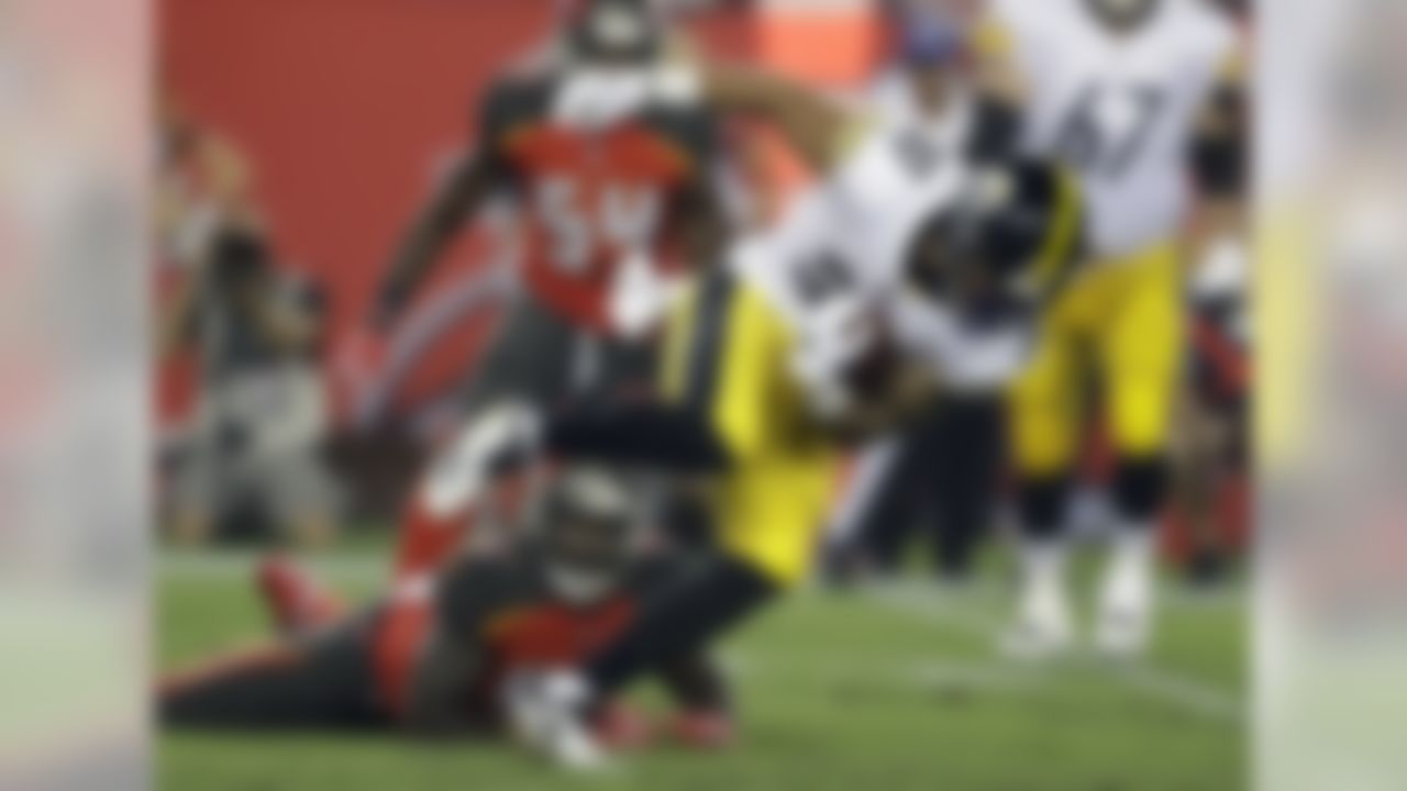 Pittsburgh Steelers running back James Conner (30) gets tripped up by Tampa Bay Buccaneers defensive tackle Vinny Curry (97) during the first half of an NFL football game Monday, Sept. 24, 2018, in Tampa, Fla. (AP Photo/Chris O'Meara)