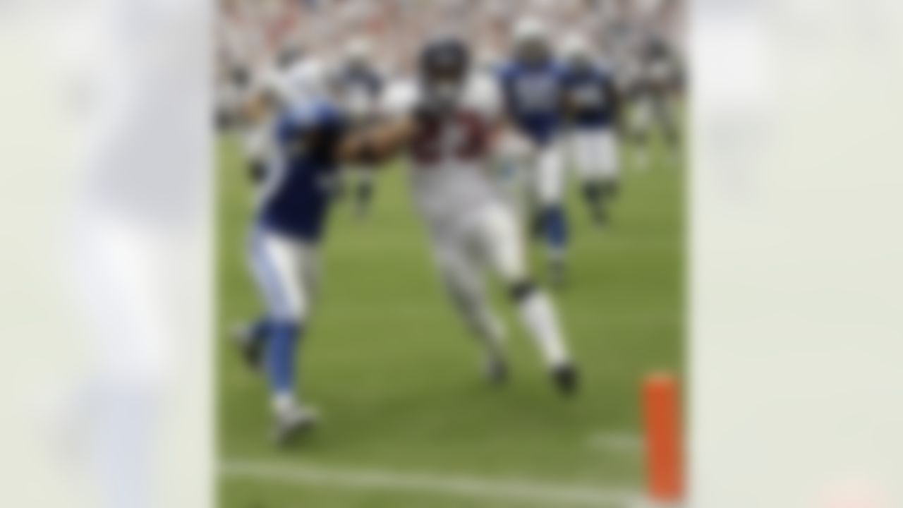 Houston Texans running back Arian Foster (23) runs for a 25-yard touchdown as Indianapolis Colts safety Melvin Bullitt (33) tries to tackle him during the fourth quarter of an NFL football game Sunday, Sept. 12, 2010, in Houston. Foster had three touchdowns in the Texans' 34-24 win. (AP Photo/David J. Phillip)