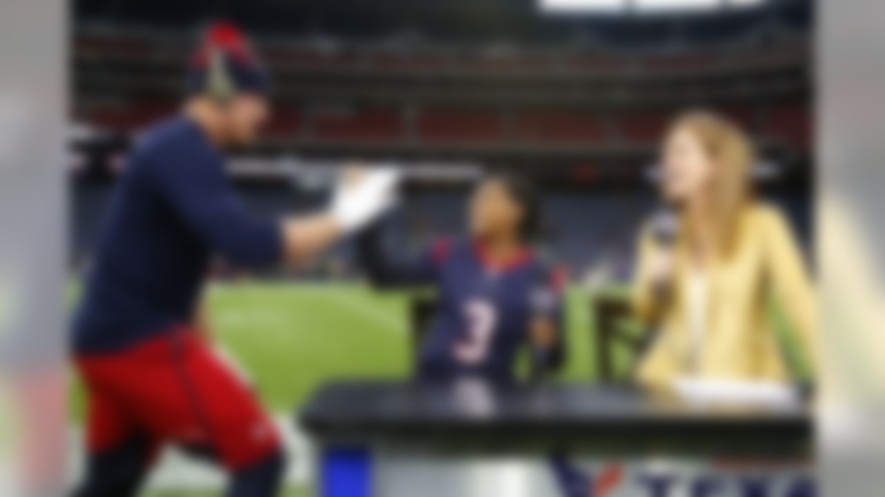 Houston Texans home field advantage team captain, the most decorated American female gymnast in World Championships history, Simone Biles is surprised by and is greeted by J.J. Watt (99) during pre game ceremonies with Fox southwest Houston's Patti Smith before a Week 12  NFL game against the New Orleans Saints on Sunday, Nov. 29, 2015 in Houston. The Texans won the game 24-6. (Matt Patterson via AP)