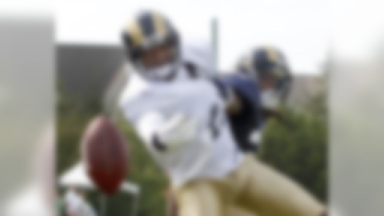 St. Louis Rams wide receiver Brandon Gibson, left, reaches for a pass as cornerback Chris Smith defends during NFL football training camp Thursday, Aug. 4, 2011, in St. Louis. (AP Photo/Jeff Roberson)