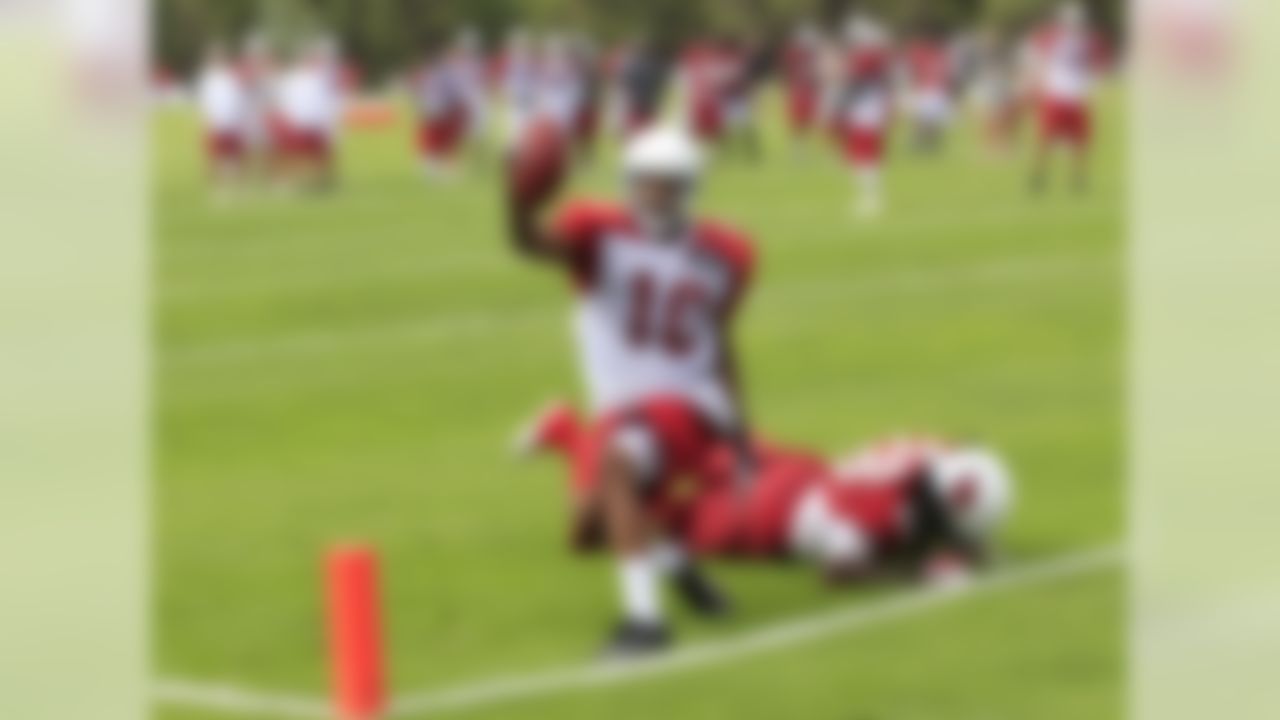 Arizona Cardinals' DeMarco Sampson (10) celebrates his touchdown catch as Greg Toler (28) stays on the ground during NFL training camp football practice at Northern Arizona University Friday, July 27, 2012, in Flagstaff, Ariz.(AP Photo/Ross D. Franklin)