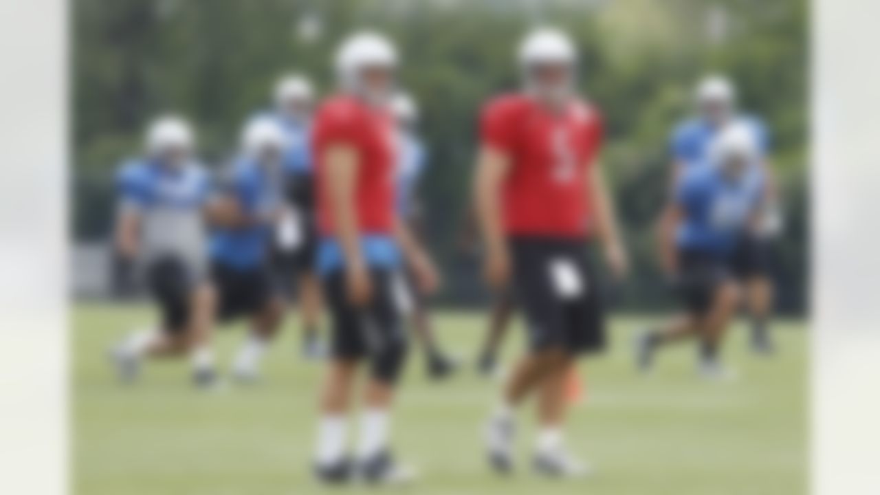 Detroit Lions quarterbacks Matthew Stafford, left, and Drew Stanton wait for the start of drills at the Detroit Lions training camp facility in Allen Park, Mich., Sunday, Aug. 1, 2010. (AP Photo/Carlos Osorio)