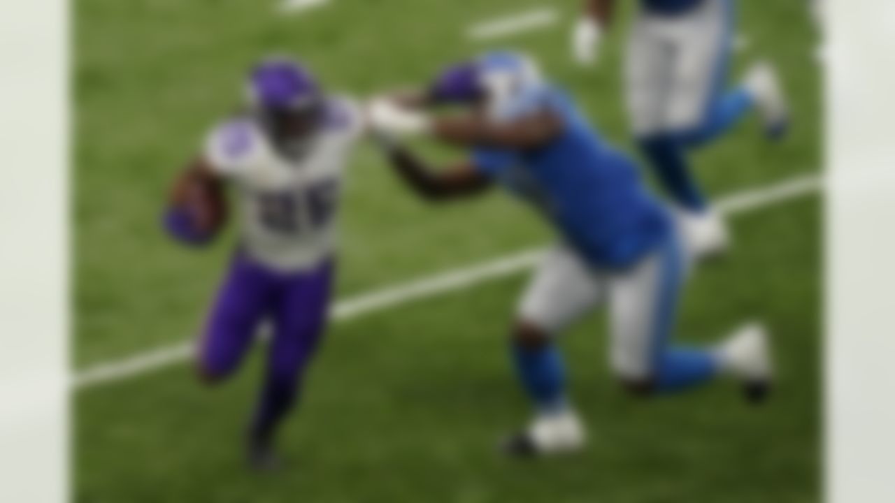 Minnesota Vikings running back Alexander Mattison (25) stiff arms Detroit Lions inside linebacker Reggie Ragland (59) during the second half of an NFL football game, Sunday, Jan. 3, 2021, in Detroit.