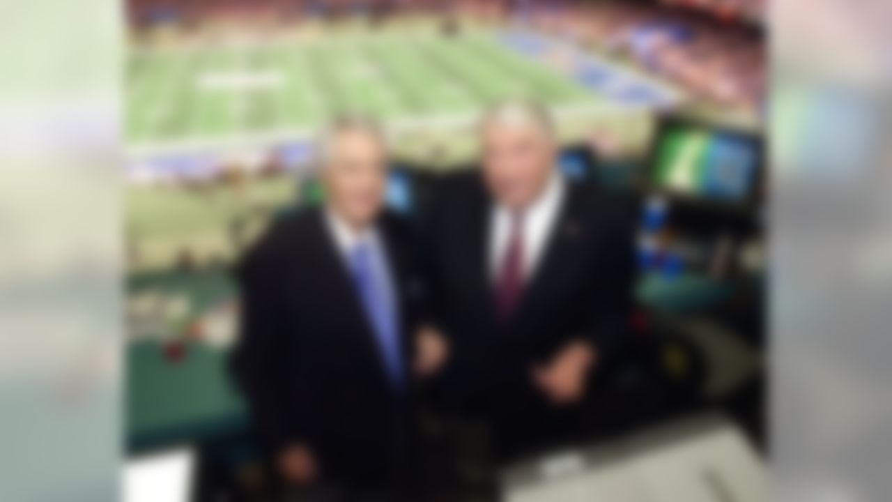 Fox broadcasters Pat Summerall, left, and John Madden stand in the FOX broadcast booth at the Louisiana Superdome before Super Bowl XXXVI in New Orleans on Feb. 3, 2002.