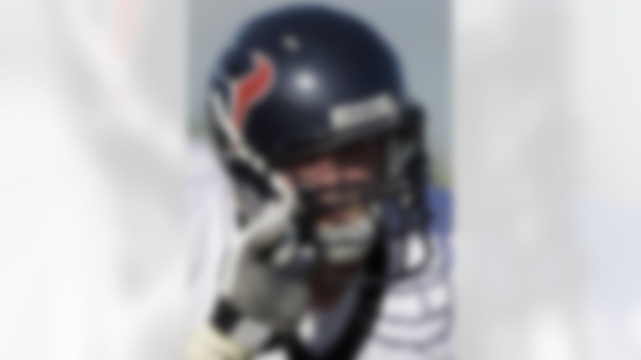 Houston Texans defensive tackle Earl Mitchell sticks his fingers in the facemask of center Brett Helms, right, during the team's first NFL training camp practice of the season Friday, July 30, 2010 in Houston. (AP Photo/David J. Phillip)