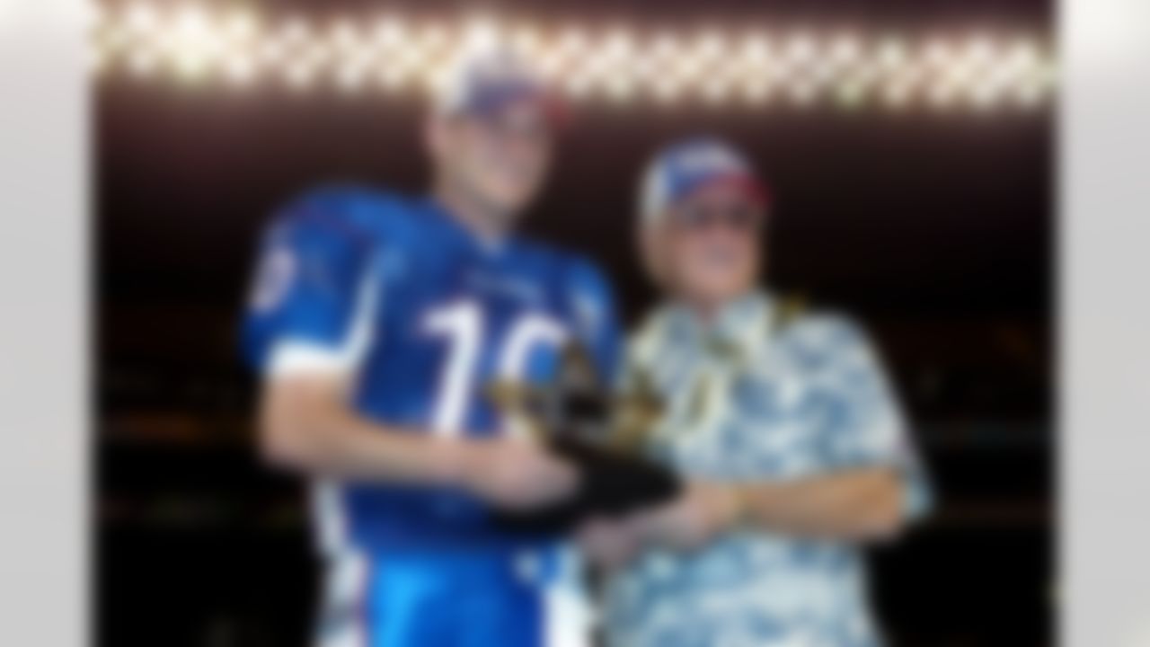 St. Louis Rams quarterback Marc Bulger accepts the Dan McGuire MVP Trophy and the keys to a new Caddilac as the most valuable player in the 2004 Pro Bowl. Participating in the award ceremony were Don Shula, ESPN's Suzy Kolber, and a representative from Caddilac. Bulger threw a record four touchdowns as the NFC came back to win the game by a record total score of 55 to 52 over the AFC in Hawaii on February 8, 2004. (AP Photo/Paul Spinelli)