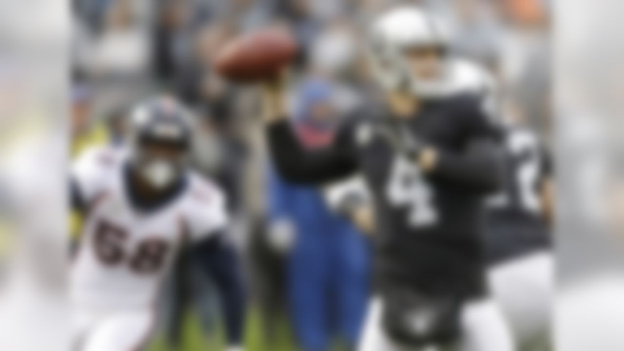 Oakland Raiders quarterback Derek Carr (4) passes in front of Denver Broncos linebacker Von Miller (58) during the first half of an NFL football game in Oakland, Calif., Sunday, Nov. 26, 2017. (AP Photo/Ben Margot)