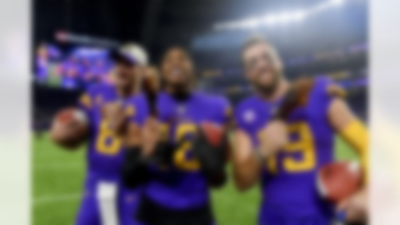 Minnesota Vikings quarterback Kirk Cousins (8), wide receiver Justin Jefferson (18) and wide receiver Adam Thielen (19) eat turkey to celebrate Thanksgiving after an NFL football game against the New England Patriots on Thursday, November 24, 2022 in Minneapolis, Minnesota.