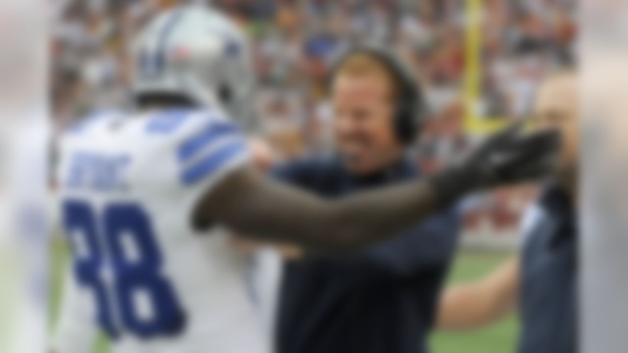 Dallas Cowboys wide receiver Dez Bryant (88) celebrates his touchdown with head coach Jason Garrett during the first half of an NFL football game against the Washington Redskins in Landover, Md., Sunday, Dec. 28, 2014. (AP Photo/Richard Lipski)