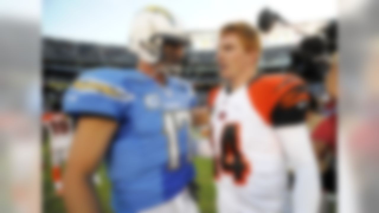 San Diego Chargers quarterback Philip Rivers (17), left, talks with Cincinnati Bengals quarterback Andy Dalton (14) after an NFL football game Sunday, Dec. 1, 2013, in San Diego. The Bengals won 17-10. (AP Photo/Denis Poroy)