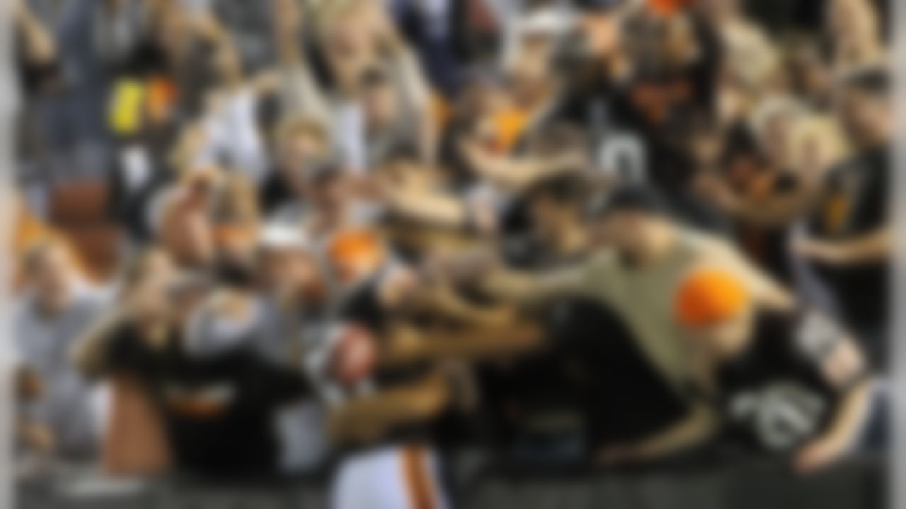 Cleveland Browns linebacker Alex Hall is mobbed by fans after intercepting a pass from Tennessee Titans quarterback Vince Young in the third quarter during a preseason NFL football game at Cleveland Browns Stadium, Saturday, Aug. 29, 2009, in Cleveland. The Browns won 23-17. (AP Photo/David Richard)