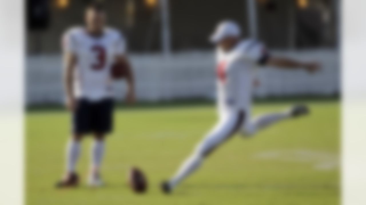 Houston Texans kicker Neil Rackers (4) kicks a field goal as kicker Kris Brown (3) watches during a NFL football training camp practice Tuesday, Aug. 3, 2010 in Houston. Brown and Rackers are battling for the kicker position on the team. (AP Photo/David J. Phillip)