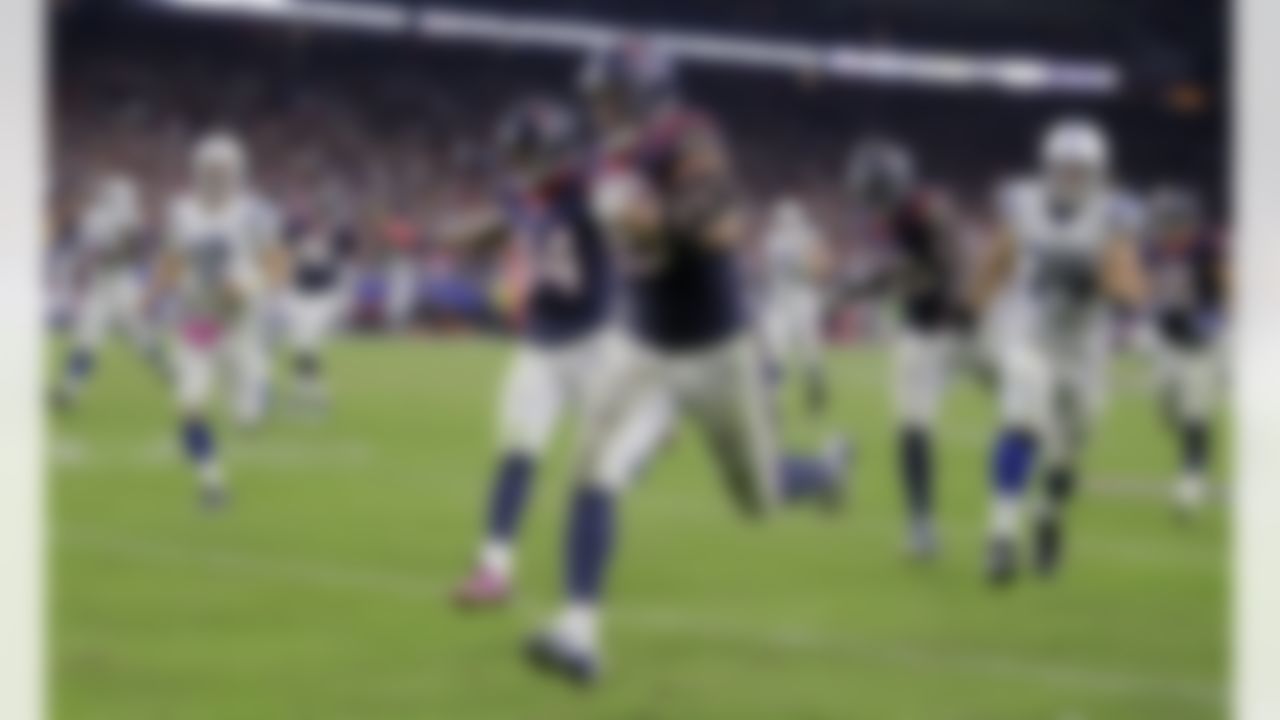 Houston Texans' J.J. Watt (99) returns a rumble against Indianapolis Colts for a 45-yard touchdown during the second half of an NFL football game, Thursday, Oct. 9, 2014, in Houston. (AP Photo/Patric Schneider)