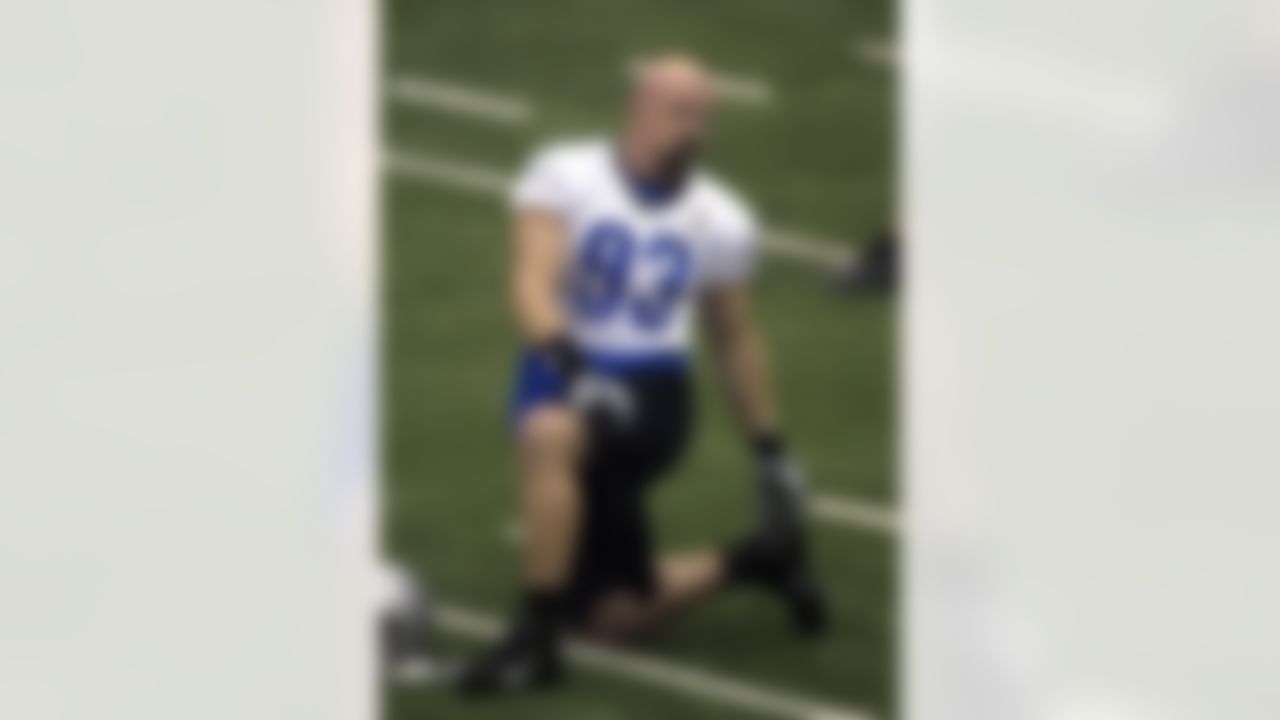 Detroit Lions defensive end Kyle VandenBosch stretches before drills at the team's NFL football training facility in Allen Park, Mich., Friday, July 27, 2012. (AP Photo/Carlos Osorio)