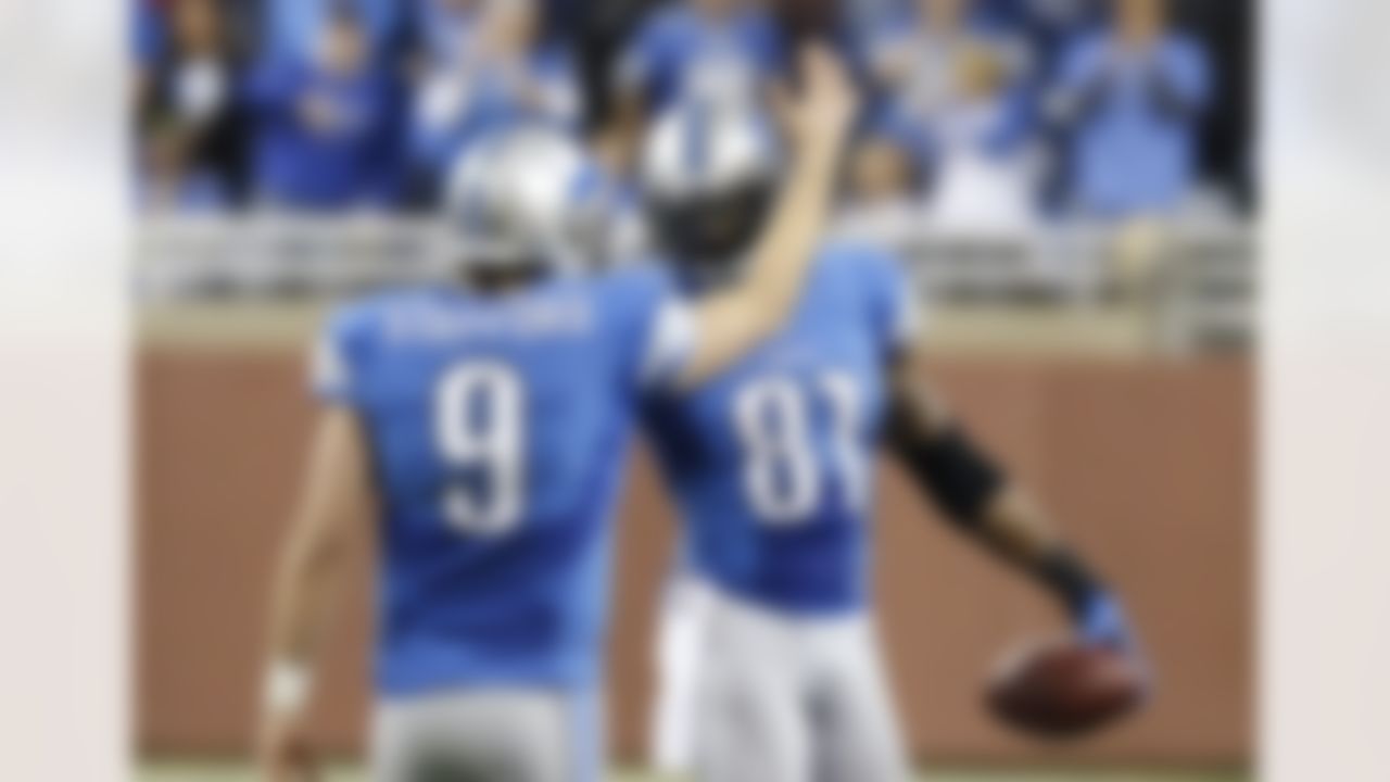 Detroit Lions wide receiver Calvin Johnson (81) is congratulated by quarterback Matthew Stafford in the fourth quarter of an NFL football game against the Atlanta Falcons, after breaking Jerry Rice's single-season record for receiving yards, in Detroit on Saturday, Dec. 22, 2012. (AP Photo/Duane Burleson)