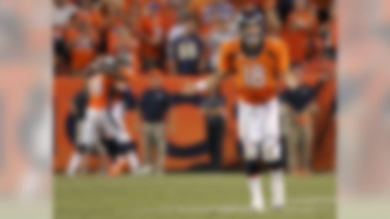 Denver Broncos quarterback Peyton Manning (18) celebrates his seventh touchdown pass of the game against the Baltimore Ravens during the second half of an NFL football game, Thursday, Sept. 5, 2013, in Denver. The Broncos won 49-27. Manning threw a record-tying seven touchdown passes ? something no one had done in 44 years. (AP Photo/Jack Dempsey)