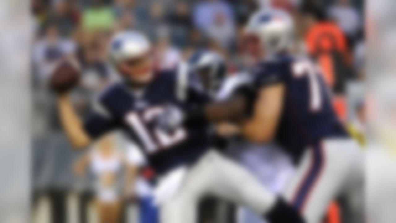 New England Patriots quarterback Tom Brady, left, tries to pass the ball as Philadelphia Eagles defensive tackle Fletcher Cox, center, breaks past Patriots tackle Nate Solder during the first half of a preseason NFL football game on Friday, Aug. 9, 2013, in Philadelphia. (AP Photo/Michael Perez)