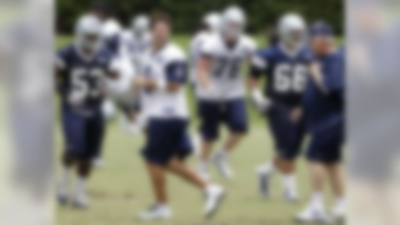 Dallas Cowboys quarterback Tony Romo (9) laughs as he talks with coach Wade Phillips, right, at the teams training facility during NFL football minicamp Saturday, June 12, 2010, in Irving, Texas. (AP Photo/Tony Gutierrez)