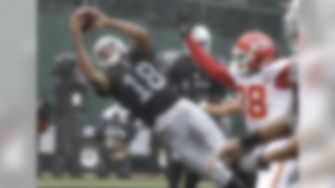 Oakland Raiders wide receiver Andre Holmes (18) catches a touchdown pass next to Kansas City Chiefs defensive back Ron Parker (38) during the first half of an NFL football game in Oakland, Calif., Sunday, Oct. 16, 2016. (AP Photo/Ben Margot)