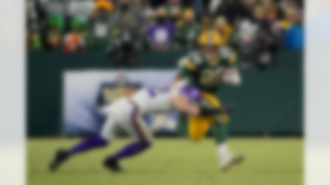 Green Bay Packers running back A.J. Dillon (28) runs the ball during an NFL football game against the Minnesota Vikings on Sunday, January 2, 2022 in Green Bay, Wisconsin.