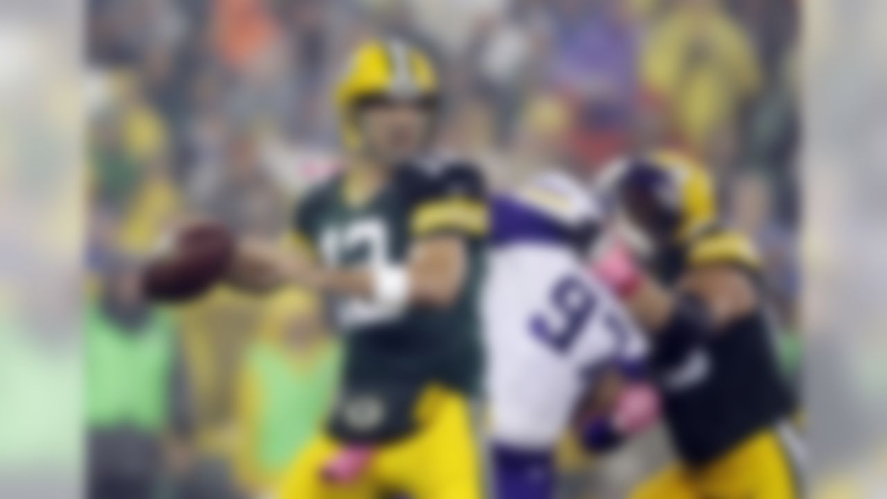 Green Bay Packers' Aaron Rodgers drops back to pass during the first half of an NFL football game against the Minnesota Vikings Thursday, Oct. 2, 2014, in Green Bay, Wis. (AP Photo/Tom Lynn)