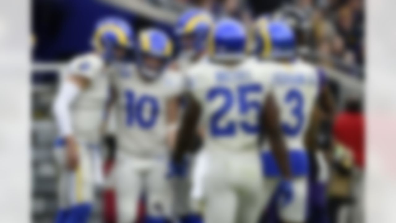 Los Angeles Rams wide receiver Cooper Kupp (10) and quarterback Matthew Stafford (9) are joined by teammates after they connected for a touchdown pass against the Baltimore Ravens during the first half of an NFL football game, Sunday, Jan. 2, 2022, in Baltimore.