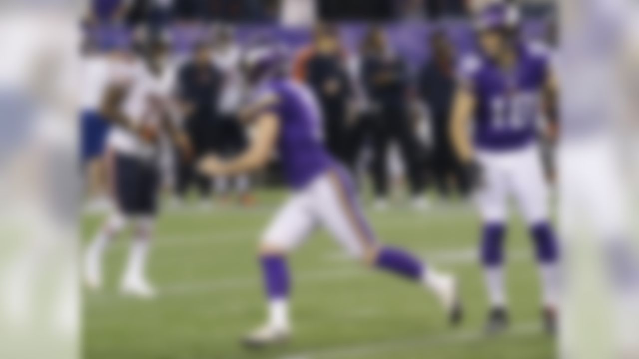 Minnesota Vikings kicker Blair Walsh, center, celebrates in front of teammate Jeff Locke, right, and Chicago Bears cornerback Tim Jennings, left, after kicking a 34-yard field goal during overtime of an NFL football game on Sunday, Dec. 1, 2013, in Minneapolis. The Vikings won 23-20. (AP Photo/Ann Heisenfelt)