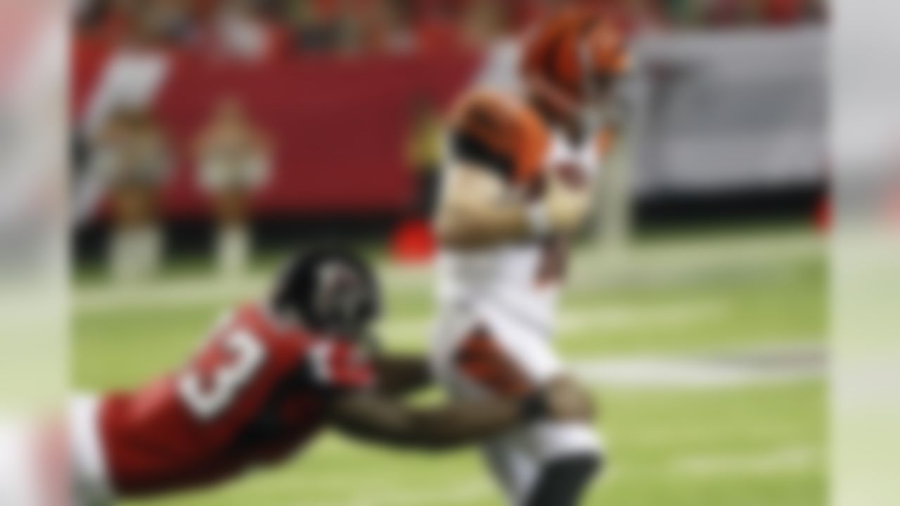 Cincinnati Bengals quarterback Andy Dalton (14) heads for the sidelines as Atlanta Falcons defensive end Ray Edwards (93) attempts a tackle during the first half of an NFL preseason football game, Thursday, Aug. 16, 2012, in Atlanta. (AP Photo/John Bazemore)