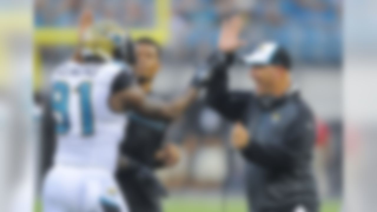 Jacksonville Jaguars head coach Gus Bradley, right, celebrates a big play with defensive end Chris Clemons (91) during the first half of an NFL preseason football game in Jacksonville, Fla., Friday, Aug. 8, 2014. (AP Photo/Stephen B. Morton)