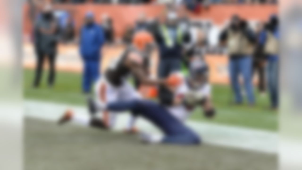 Houston Texans defensive end J.J. Watt (99) catches a touchdown pass against the Cleveland Browns in a week eleven NFL football game in Cleveland on Sunday, Nov. 16, 2014. Cleveland Browns linebacker Chris Kirksey (58) defends. (AP Photo/Matt Patterson)