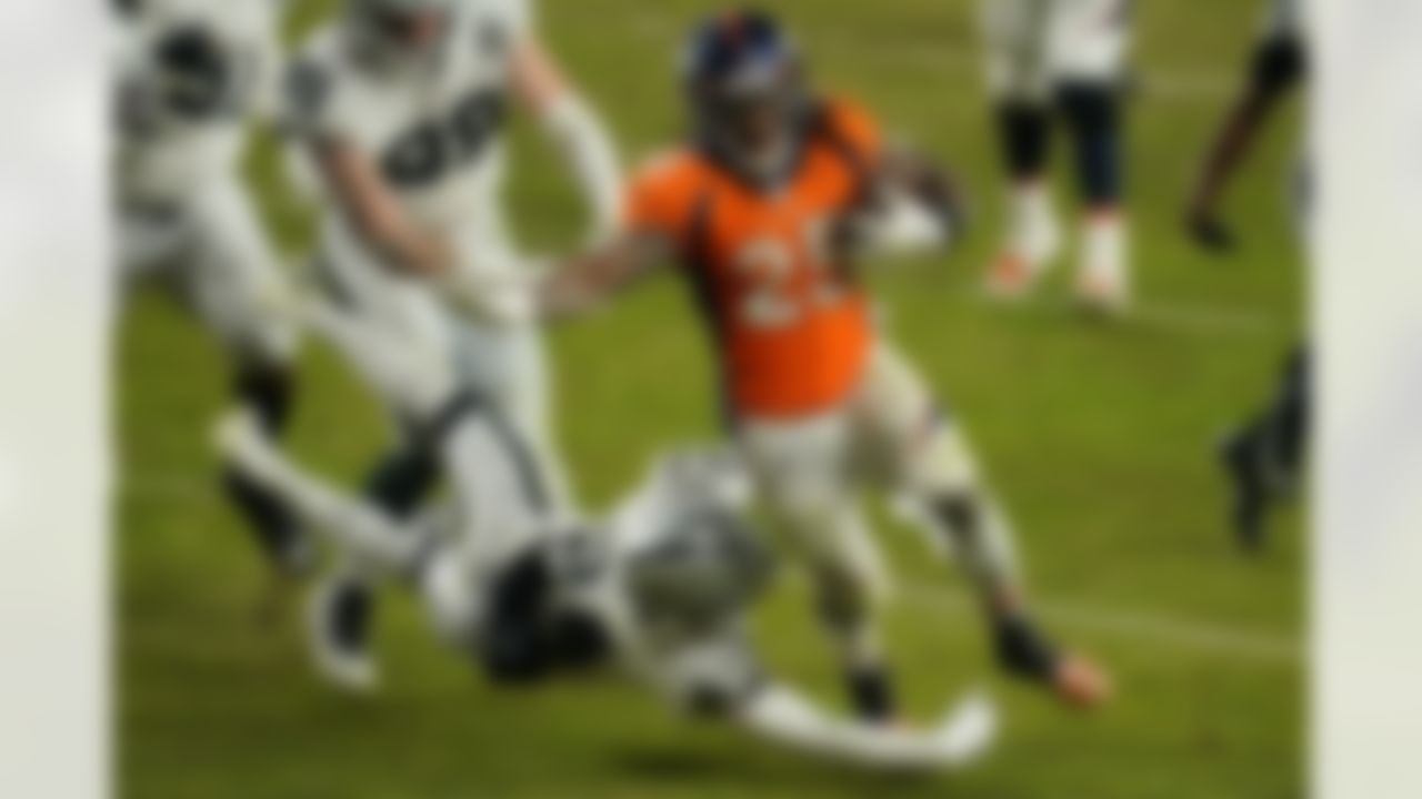 Denver Broncos running back Melvin Gordon (25) avoids a tackle by Las Vegas Raiders strong safety Johnathan Abram (24) to run it in for a touchdown during the second half of an NFL football game, Sunday, Jan. 3, 2021, in Denver.