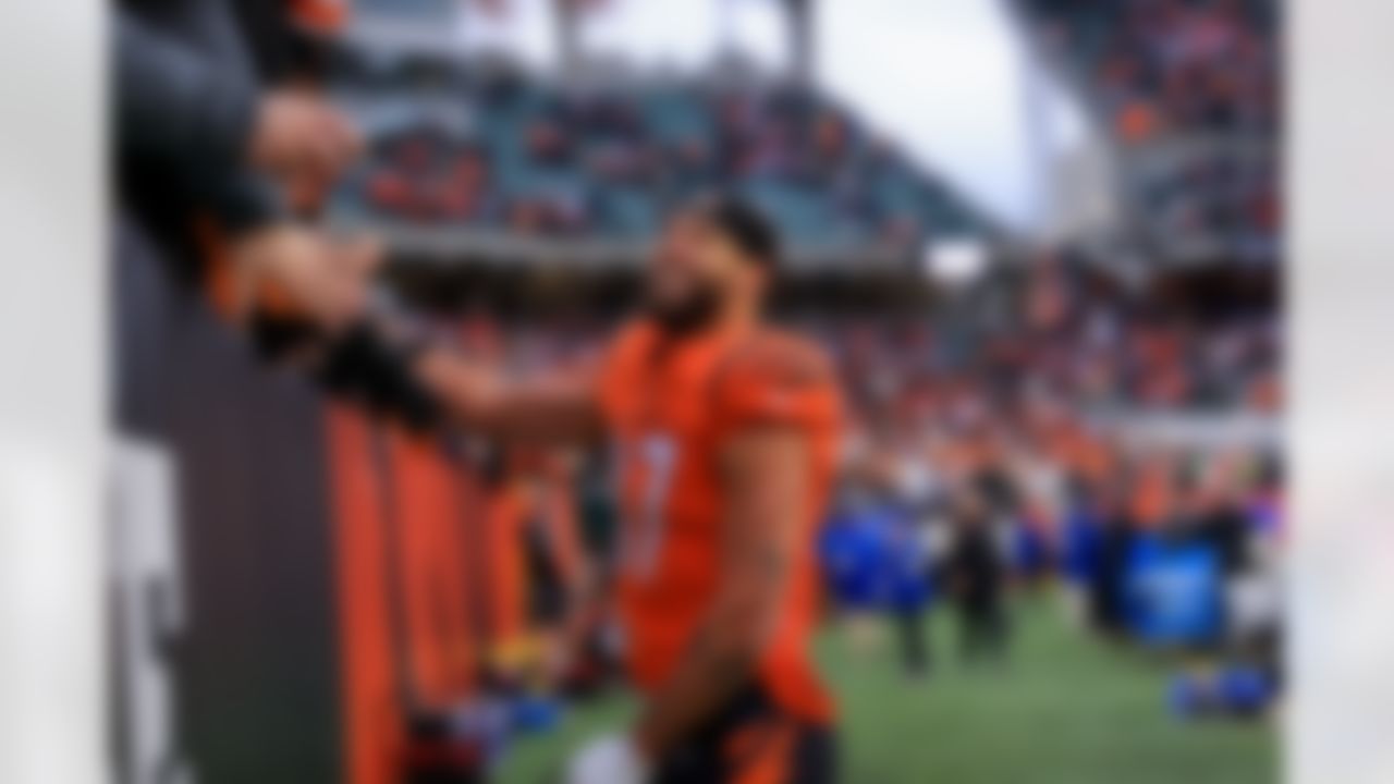 Cincinnati Bengals tight end C.J. Uzomah (87) smiles as he high fives fans leaving the field after a last-second win of an NFL football game against the Kansas City Chiefs on Sunday, January 2, 2022 in Cincinnati, Ohio.