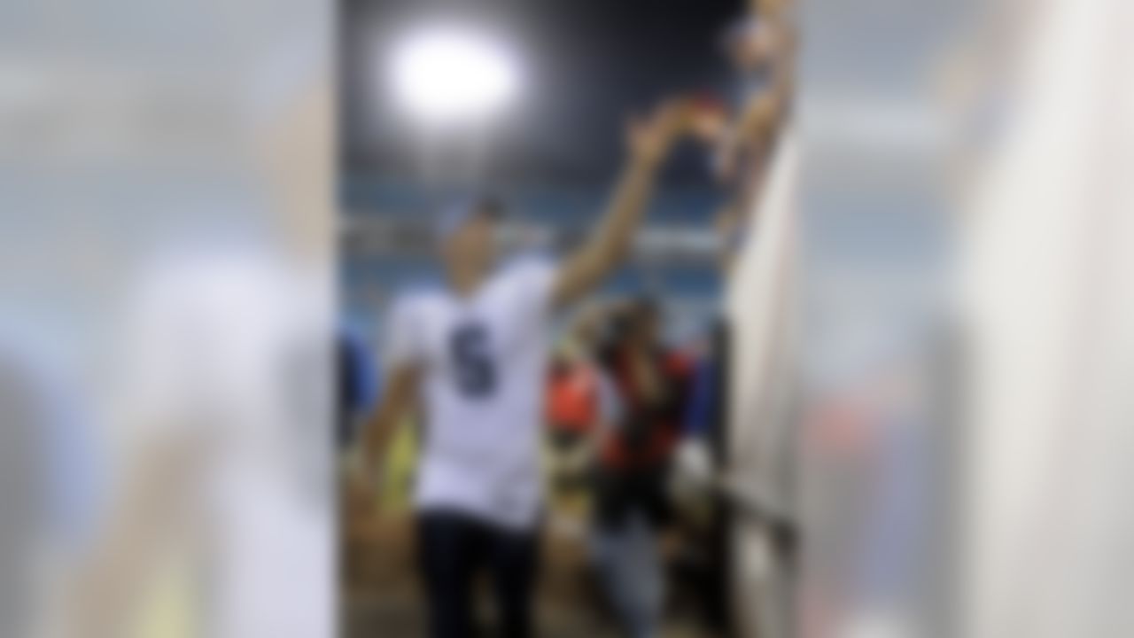 Tennessee Titans quarterback Kerry Collins throws a towel to fans in the stands while entering the tunnel after an NFL football game against the Jacksonville Jaguars in Jacksonville, Fla., Monday, Oct. 18, 2010. The Titans won 30-3. (AP Photo/Phelan M. Ebenhack)