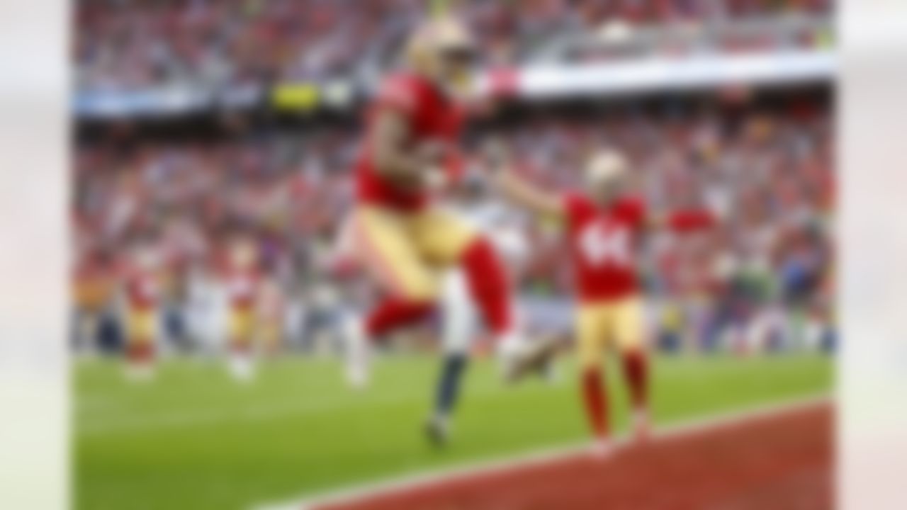 San Francisco 49ers running back Elijah Mitchell (25) runs the ball into the end zone for a touchdown during an NFL Super Wild Card Weekend playoff game against the Seattle Seahawks on Saturday, January 14, 2023 in Santa Clara, California.