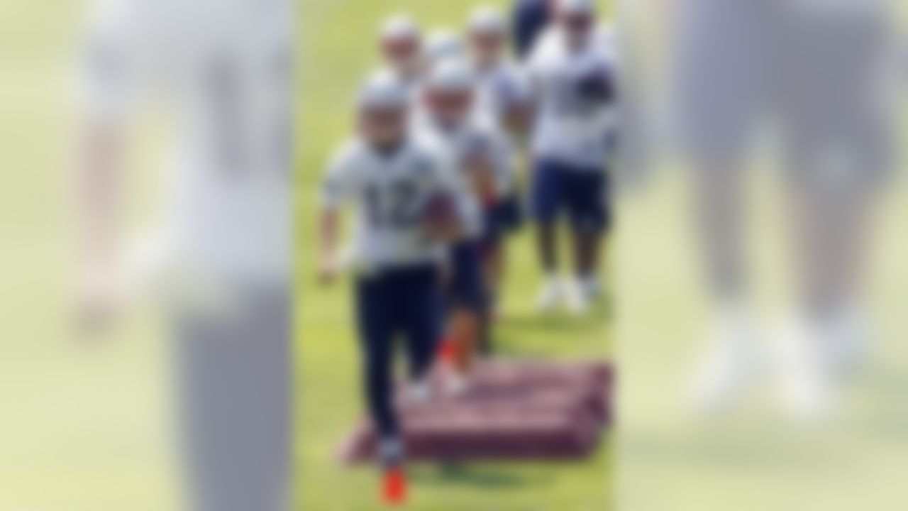 New England Patriots quarterback Tom Brady (12) runs through drills during NFL football practice in Foxborough, Mass., Wednesday, June 2, 2010. (AP Photo/Stew Milne)