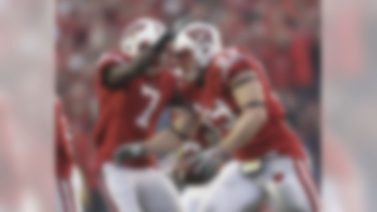 Wisconsin's J.J. Watt (99) is congratulated by Aaron Henry (7) after Watt recovered a fumble during the first half of an NCAA football game against Indiana Saturday, Nov. 13, 2010, in Madison, Wis. (AP Photo/Morry Gash)