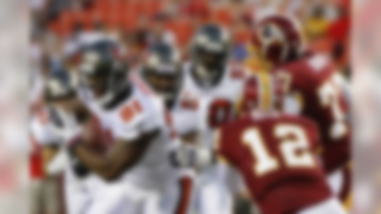 Tampa Bay Buccaneers defensive end Da'Quan Bowers (91) runs with the ball after scoping up a fumble by Washington Redskins running back Evan Royster as Washington Redskins quarterback John Beck and tackle Jammal Brown (77) reach to stop him during the first half of an NFL preseason football game in Landover, Md., on Thursday, Sept. 1, 2011.  (AP Photo/J. David Ake)