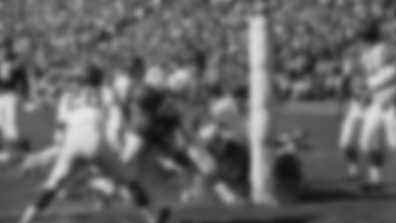 Jim Brown (32, with ball) of the Cleveland Browns and a member of the East All-Stars plunges over from the one-yard line in the first period of Pro Bowl game, Jan. 13, 1963, Los Angeles, Calif. The East score in little more than four minutes of the first period, after Bill Koman of the St. Louis Cardinals recovered a fumble on the West 26-yard line. Others in the picture include: Yale Lary (28), Gino Marchetti (83), Matt Hazeltine (48) and Bill Forester (71) of the West All-Stars; Jim Ray Smith (64) of the East.