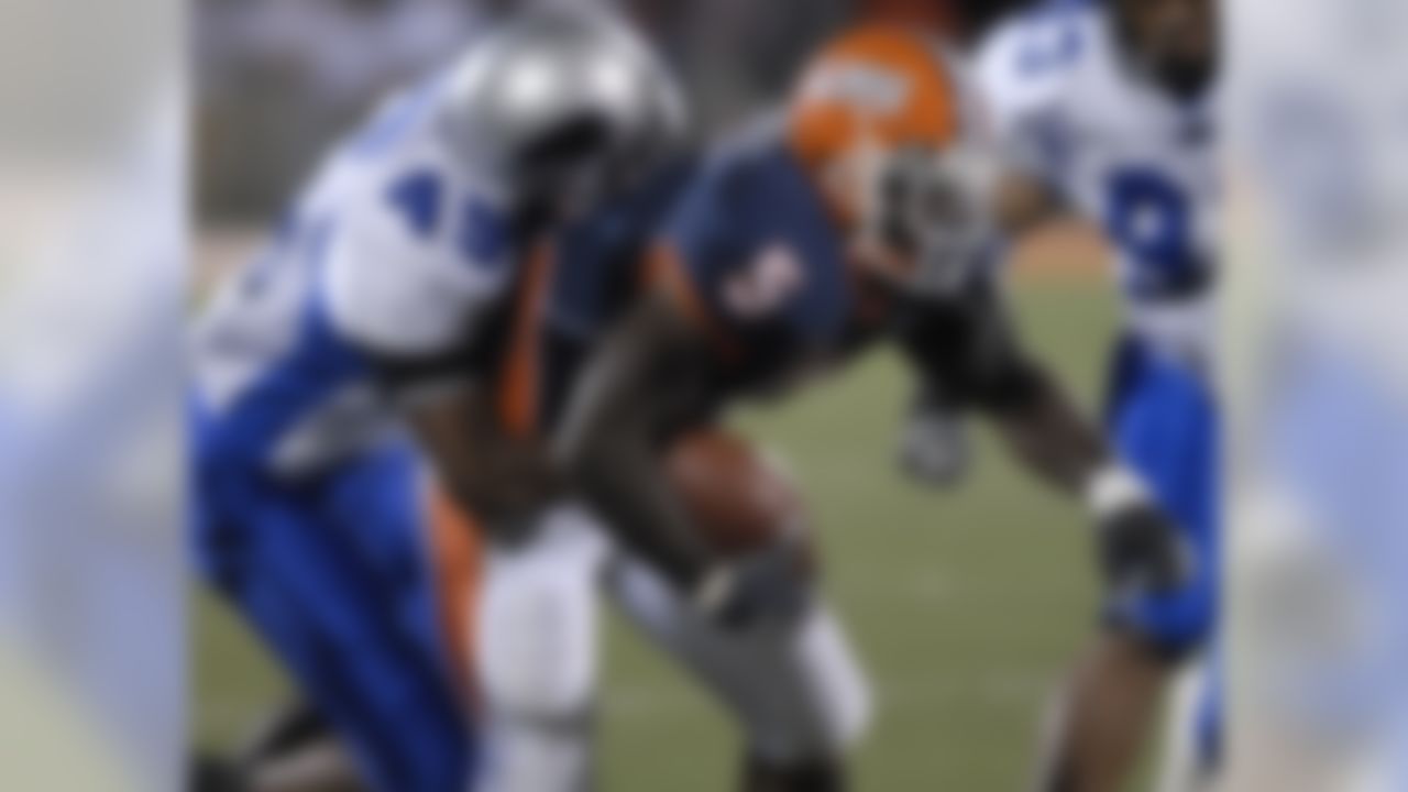 Illinois' Rashard Mendenhall (5) is stopped by Eastern Illinois' John Coci late in the fourth quarter of a football in Champaign, Ill., Sept. 2, 2006. Illinois won 42-17. (AP Photo/Darrell Hoemann)