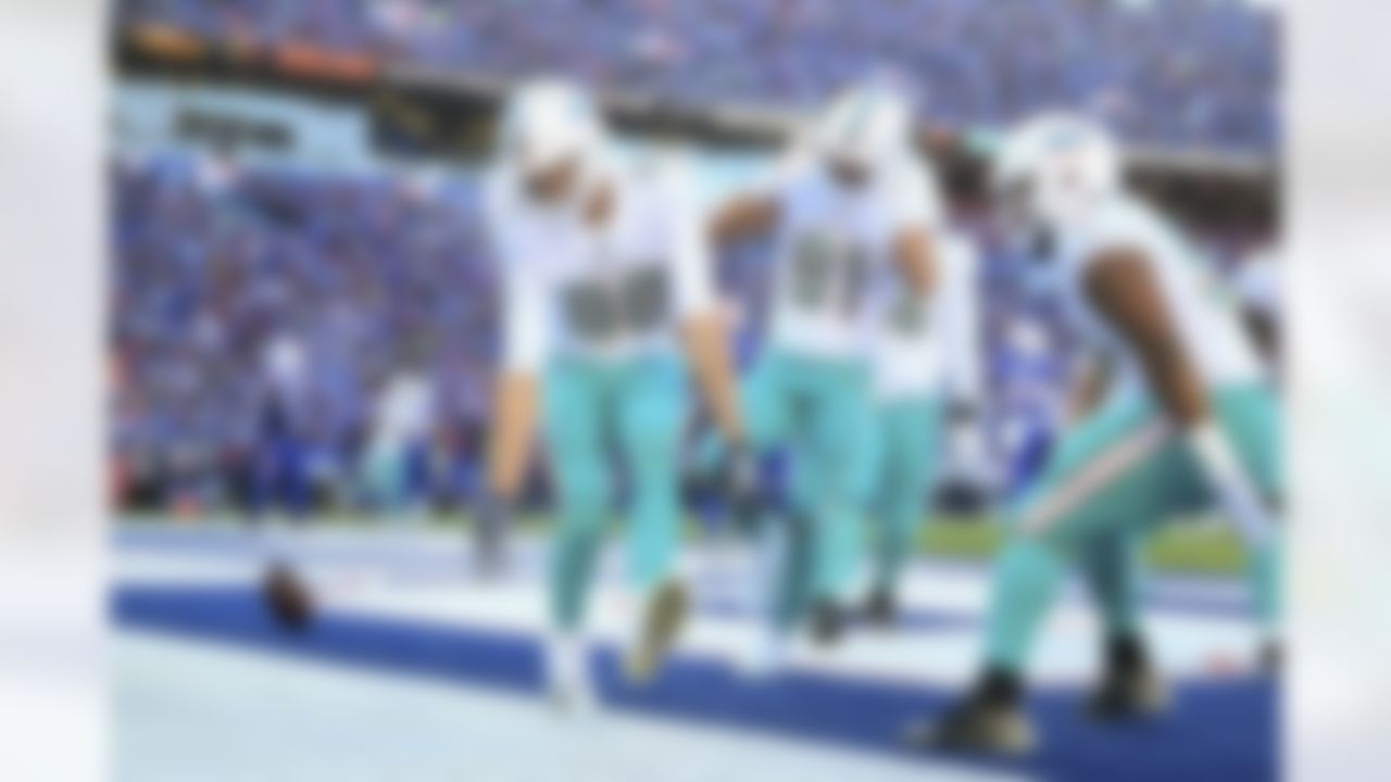 Miami Dolphins tight end Mike Gesicki (88) celebrates after scoring a touchdown during an NFL Super Wild Card Weekend playoff game against the Buffalo Bills on Sunday, January 15, 2023 in Orchard Park, New York.
