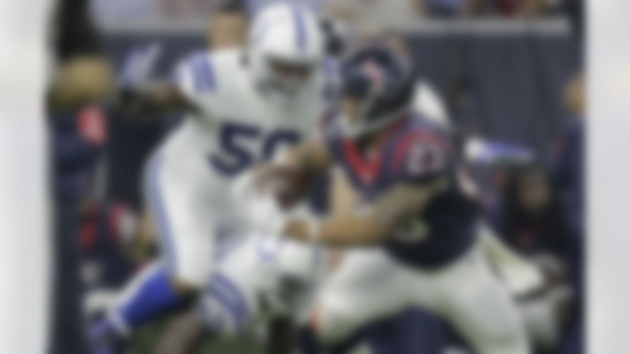 Houston Texans' Arian Foster (23) tries to escape Indianapolis Colts defenders Trent Cole (58) and D'Qwell Jackson (52) during the first half of an NFL football game Thursday, Oct. 8, 2015, in Houston. (AP Photo/Patric Schneider)