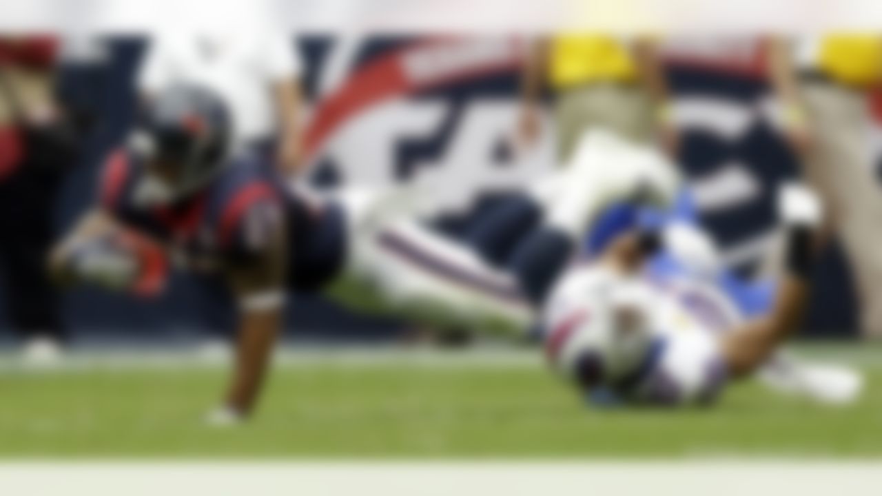 Houston Texans running back Arian Foster (23) dives for extra yards as Buffalo Bills strong safety George Wilson (37) trips him up in the first quarter of an NFL game Sunday, Nov. 4, 2012, in Houston. (AP Photo/Eric Gay)