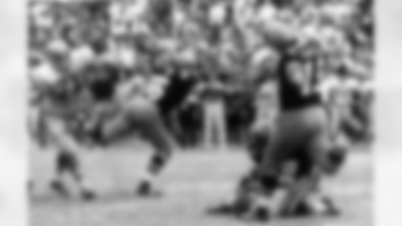 New Orleans Saints' Tom Dempsey, 19, who is missing a hand and part of his right foot, moves up to kick a 63-yard field goal in New Orleans November 8, 1970. The record-setting kick, with 2 seconds left in the game, gave the Saints an upset 19-17 win over the Detroit Lions. Lions Alex Karras, 71, rushes the kicker and Saints Bill Cody, 66, blocks while Joe Scarpati, 21, holds the ball. (AP Photo)