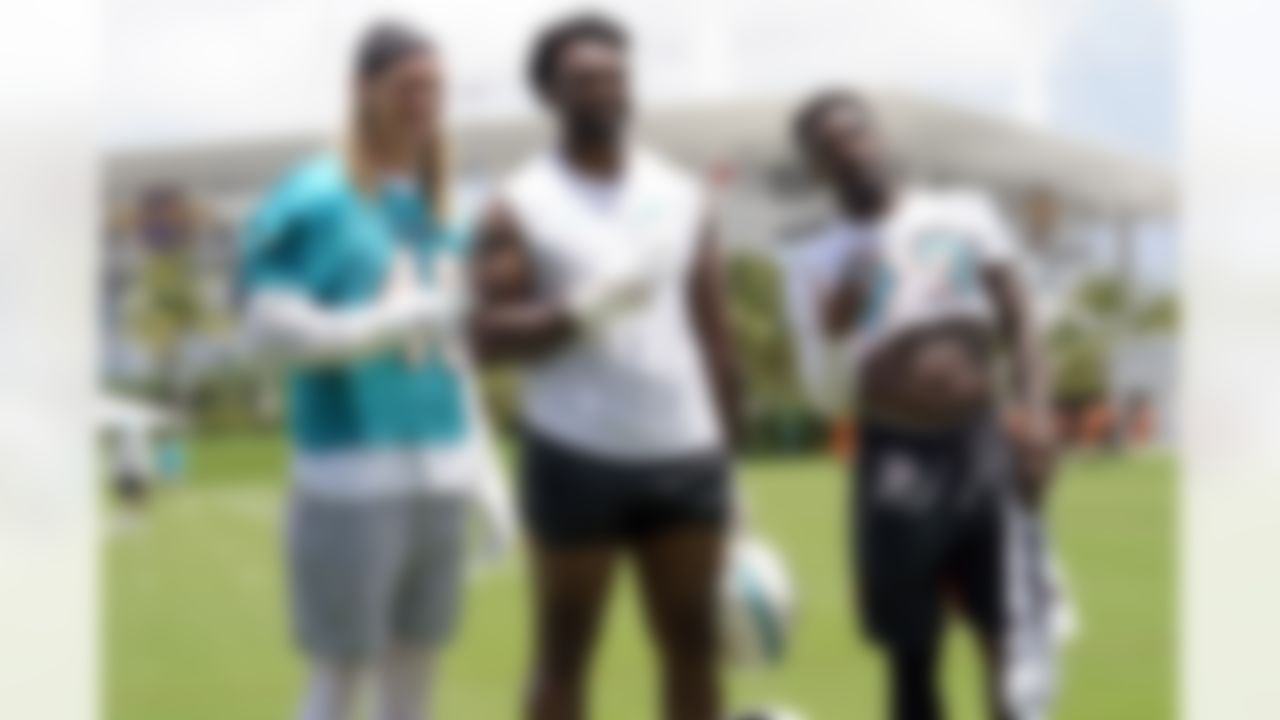Miami Dolphins linebacker Andrew Van Ginkel (43), guard Austin Jackson and running back Jeff Wilson Jr. (23) stand on the field after NFL football practice at the team's training facility, Tuesday, May 23, 2023, in Miami Gardens, Fla.