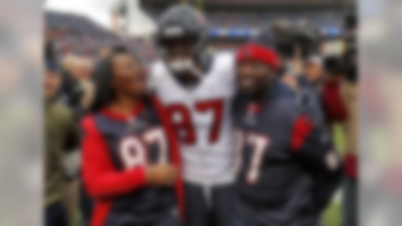 Houston Texans wide receiver Demaryius Thomas (87) stands with his parents, Bobby Thomas, right, and Katina Smith, prior to an NFL football game against the Denver Broncos, Sunday, Nov. 4, 2018, in Denver. (AP Photo/David Zalubowski)