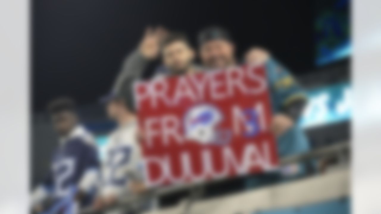 Fans display a sign honoring injured Buffalo Bills player Damar Hamlin before an NFL football game between the Jacksonville Jaguars and the Tennessee Titans, Saturday, Jan. 7, 2023, in Jacksonville, Fla.
